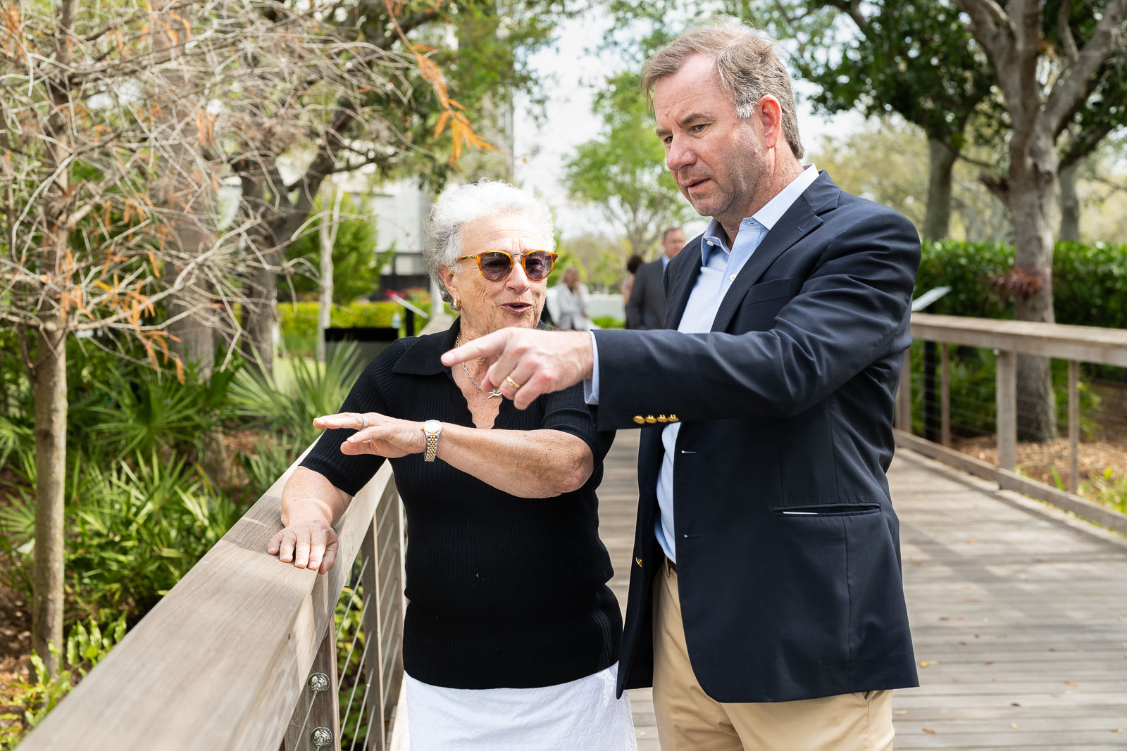 A person pointing at an older person